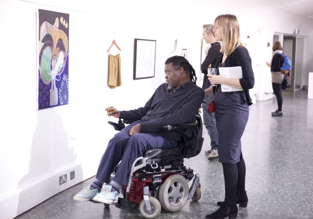 Yinka Shonibare MBE looking at the winning artwork piece in the white gallery space