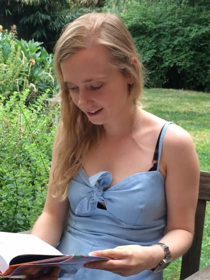 picture of jess starns reading in a sunny garden