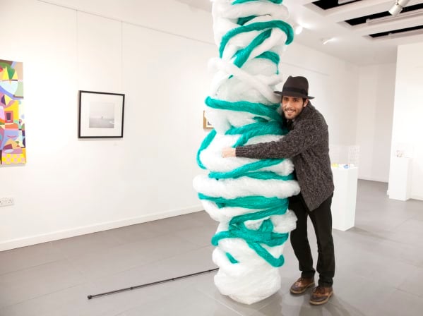 Carmen Papalia hugs a bubble-wrapped column