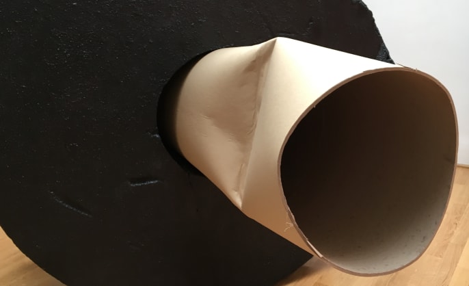 Giant toilet roll tube inside a circular object