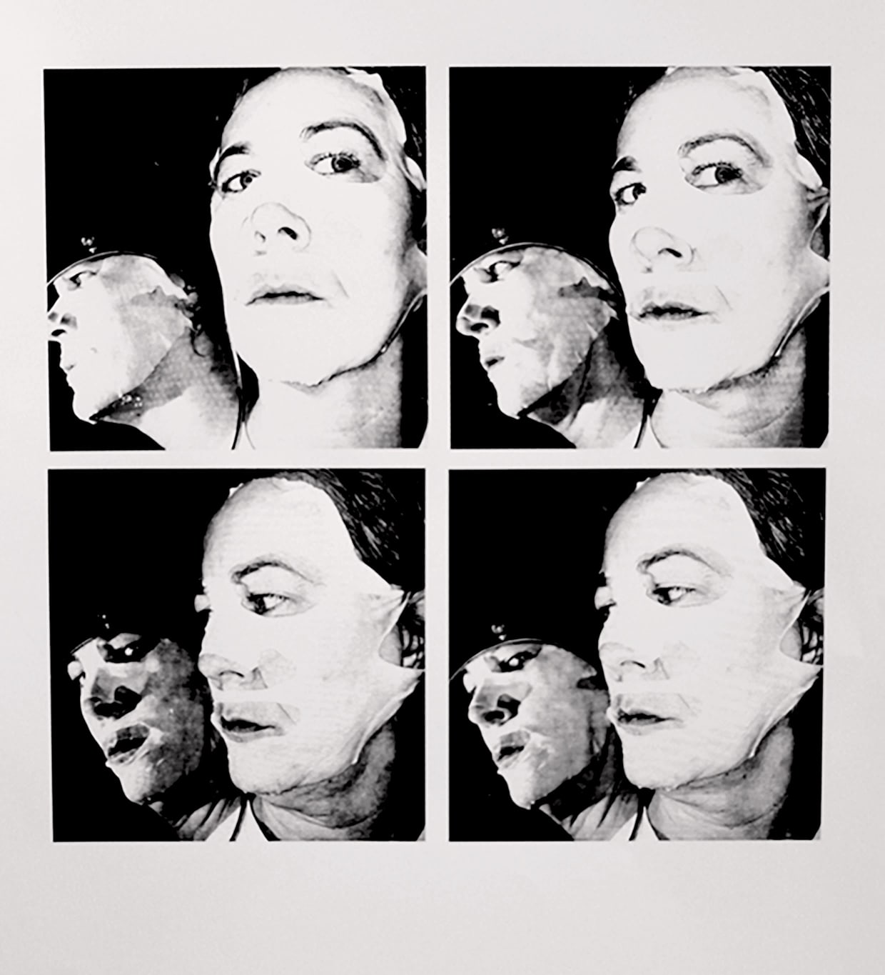 A set of four black and white photographs arranged in a square of white card. In each photo a mirror is held up to the side of a woman’s face, so that her reflection, which is shown in the image, appears to look towards us or away in relation to the mirror.