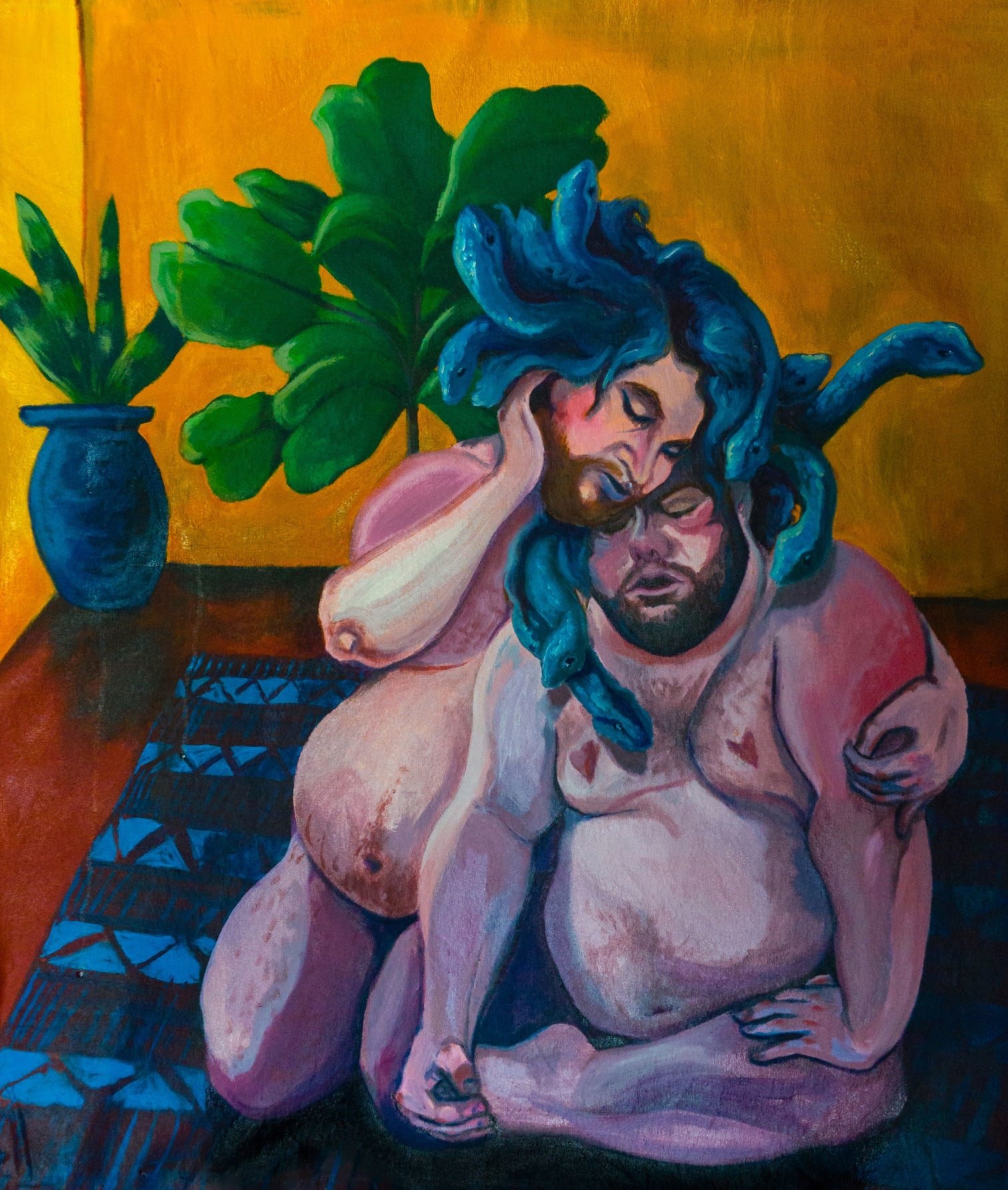 The artist describes this work as a depiction of ‘two, fat, trans, disabled bodies in [an] embrace. The embracing couple are huddled together on a blue rug in a room with warm golden walls and two bright green houseplants. The figure on the right sits with one leg crossed in-front of their belly, one hand propped on a knee and the other grasping a foot. The second figure knees and leans over. Their left arm curls around in a comforting half embrace with a cheek resting on the others forehead. Both have short, brown beards and wild hair which, on closer inspection, is a mess of medusa like blue snakes